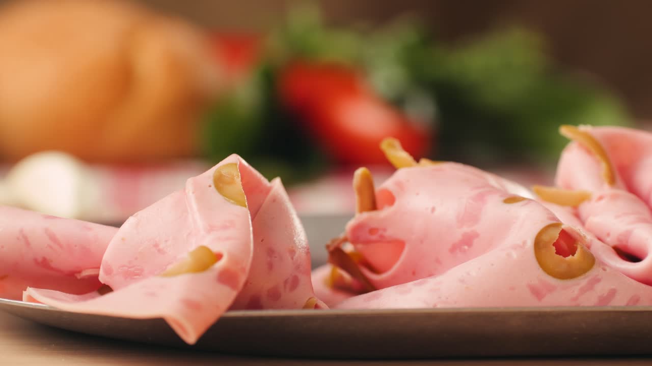 Ham italian mordatella, man Slices Of Traditional Italian antipasti mortadella sausage on a wooden cutting board, close up macro of chicken or turkey jamon, fat breakfast dish.