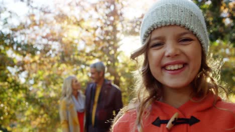 smiling girl with happy parents in backgrounds