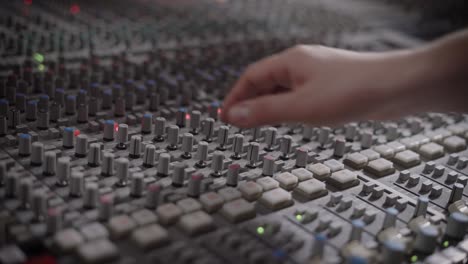 musician is working in a recording studio with a mixing console