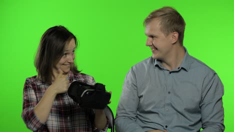 man and woman using vr headset helmet to play game. watching virtual reality 3d video. chroma key