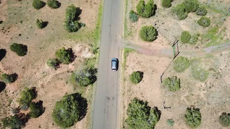 aerial tracking reveal shot of car driving on grand canyon solitary road, arizona