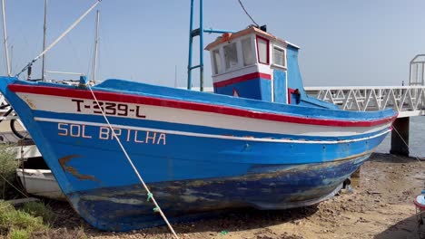 Traditional-fishing-boat-being-repaired-and-painted-to-go-back-to-its-job-of-fishing-in-the-wild-Atlantic-waters-off-Portugal