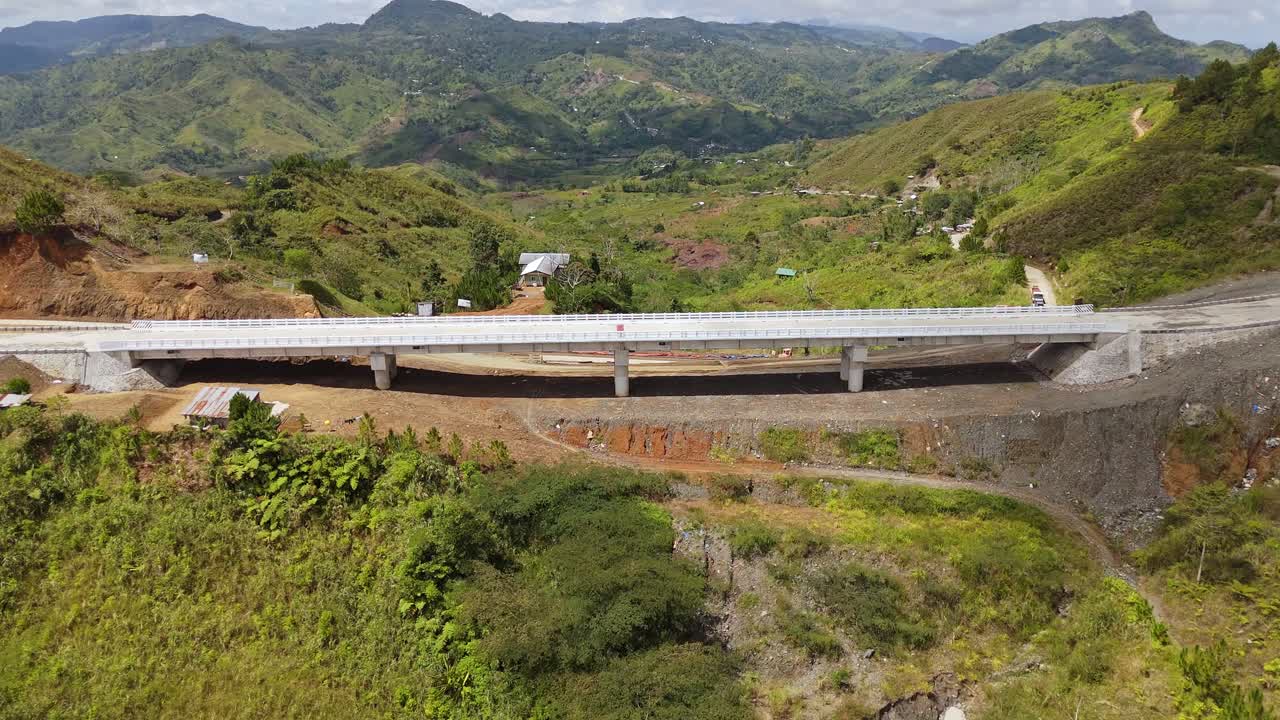 Aerial view of a modern concrete bridge in the mountains of the Philippines. Perfect for infrastructure, engineering, construction, and travel projects