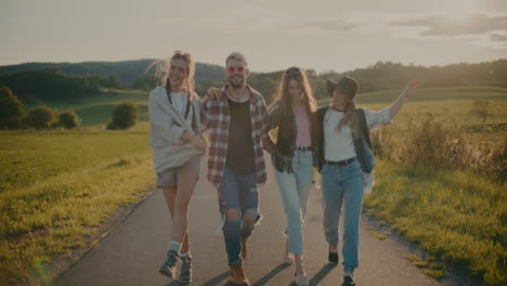 carefree friends with arm in arm walking on footpath