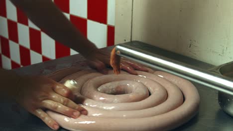 pricking with sausage poker into air pockets, to prevent the sausage from bursting