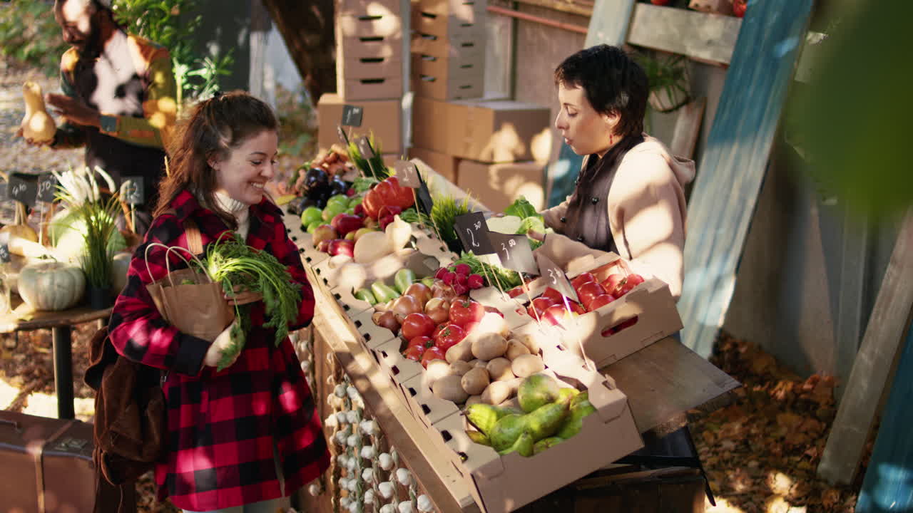Woman buying produce at market stall