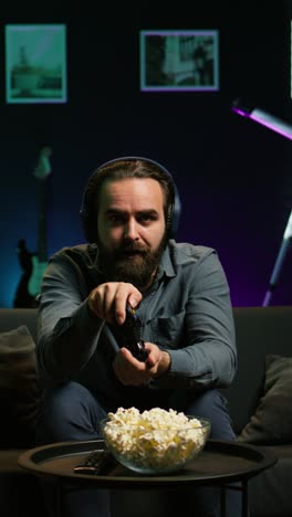 vertical video man in disbelief after losing while playing videogames, receiving game over
