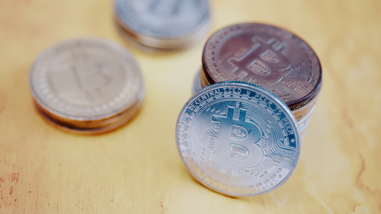Close up of shiny physical Bitcoin coins stacked on a table