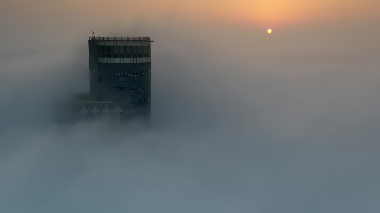 Tower Pierced Through a Misty Sunrise