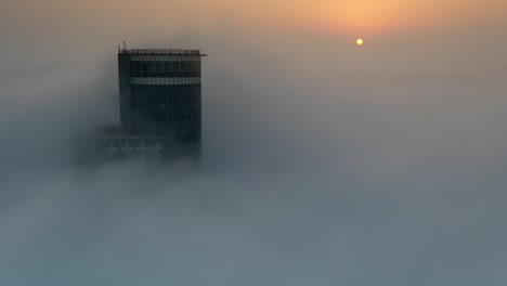 tower pierced through a misty sunrise
