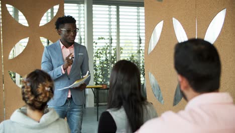 confident manager standing and talking to coworkers