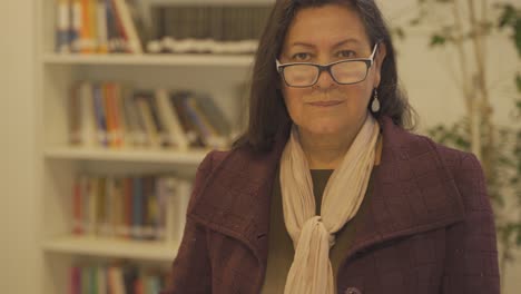 old strict secretary woman at school with glasses looking at camera,4k close up