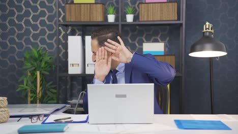 businessman looking scared at laptop.