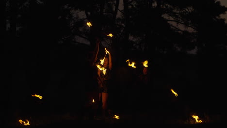 fire jugglers in the dark forest