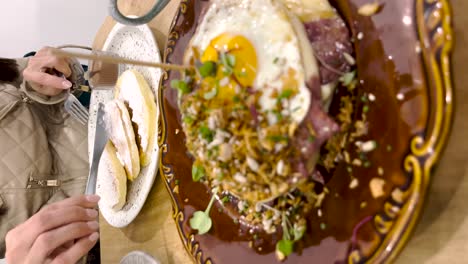 woman-spreads-chocolate-on-pancakes-with-sugar-and-cinnamon,-a-typical-treat-in-Portugal