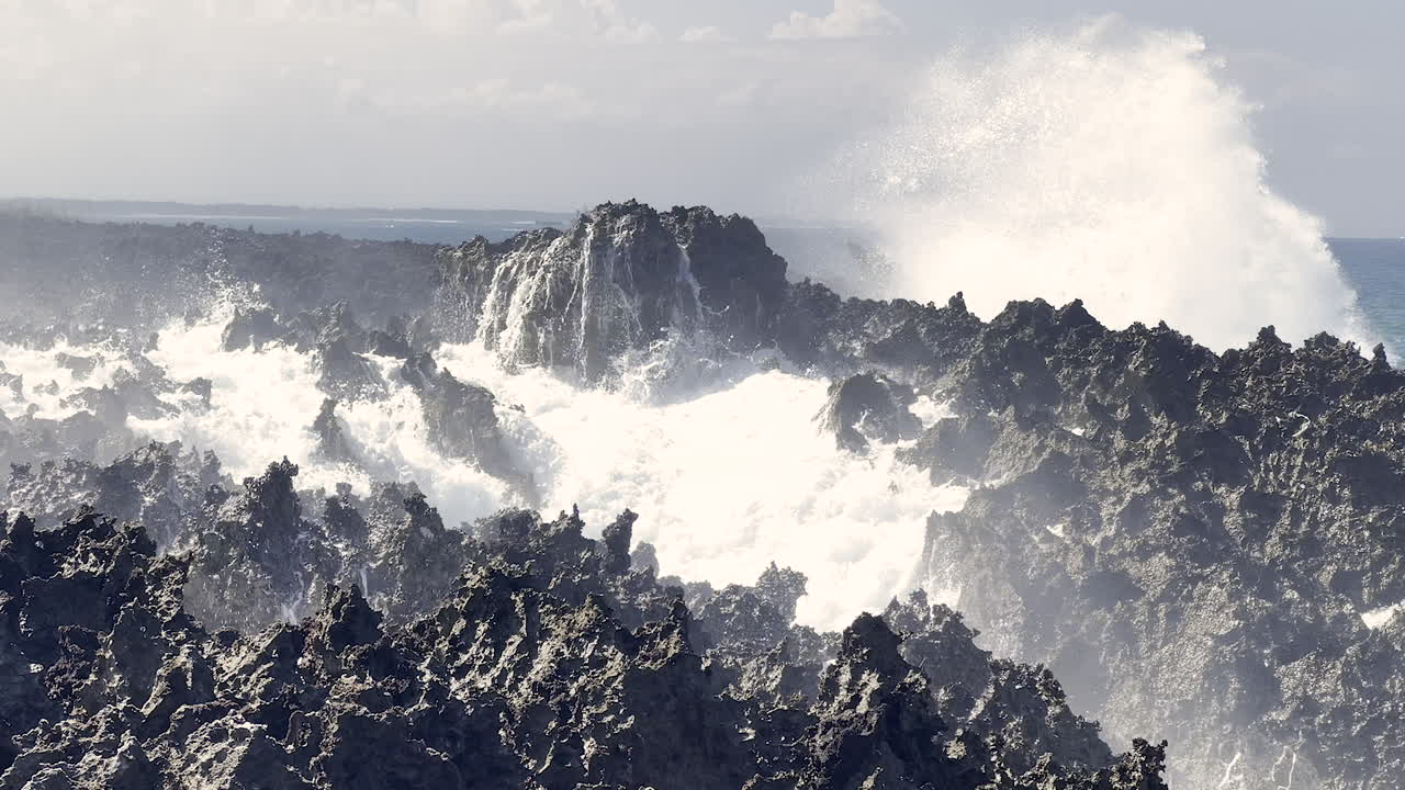 Powerful Waves Crashing Against Rugged Coastal Rocks