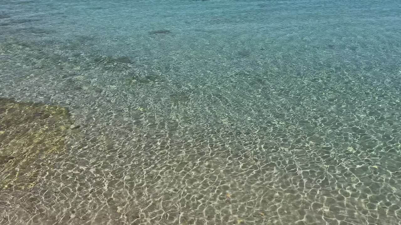 Stunning beach scene in Halkidiki, Greece, with elegant sunbeds facing the crystal-clear turquoise sea. A perfect summer escape in the heart of the Aegean.