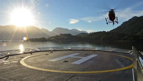 low angle of a helicopter landing on a ship helipad at sunrise near chait̩n in northern patagonia in chile