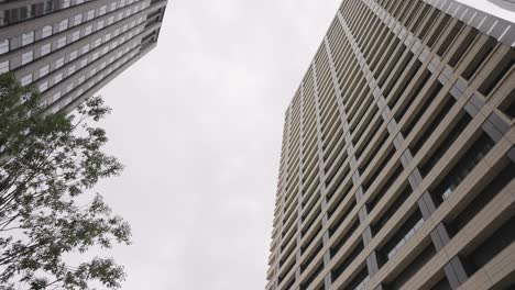 Ginza-Neighborhood,-Looking-up-at-High-Rise-Buildings,-Tokyo-Japan