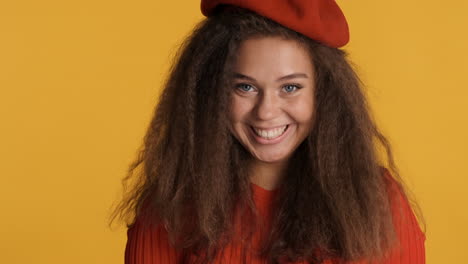 caucasian curly haired woman wearing a beret.