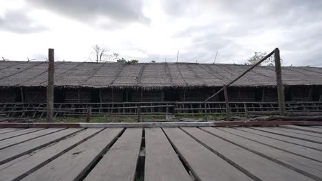 point of view pov walking old wooden bridge and house in indonesia countryside