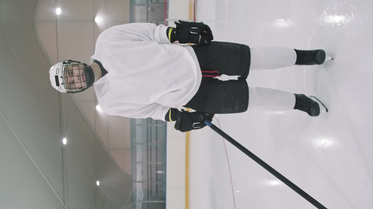 Male Hockey Player Standing On Empty Rink