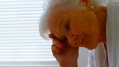 close-up of caucasian worried senior woman relaxing on bed at home 4k