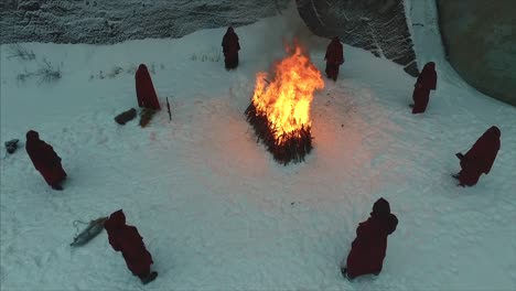 winter ritual ceremony around a fire in the snow