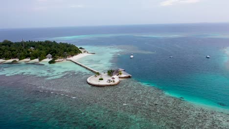 Aerial-view-of-beautiful-maldives-island-water-villa-bungalows-in-turquoise-lagoon-near-the-white-sand-beach-on-sunny-day