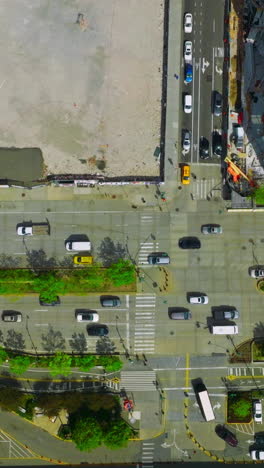 heavy traffic on the motorways of new york. vibrant city movement at daytime. bird's eye view. vertical video
