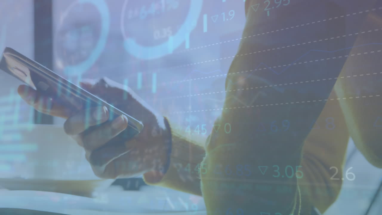 Animation of graphs and trading board over midsection of caucasian man using smartphone