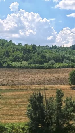 scenic fields and hills from a moving train