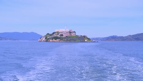 a beautiful scenic view of alcatraz island captured from a boat during a relaxing cruise. experience a picturesque view from a boat showcasing the beauty of alcatraz island surrounded by stunning scenic waters