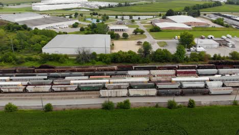 4k-aerial-view-panning-left-to-right-of-multiple-trains-and-one-starting-to-leave-the-train-station