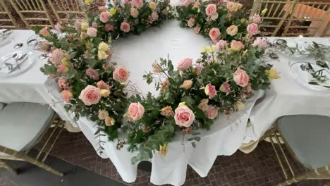 elegant, romantic ambience of a banquet set up with roses on display on the wedding tables