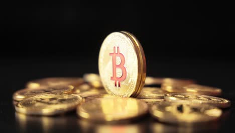 gold bit coin btc cryptocurrency coins on a black background. bitcoin is a worldwide cryptocurrency and digital payment system called the first decentralized digital currency.