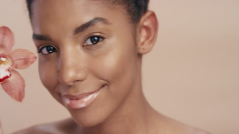 close up beauty portrait attractive african american woman touching body with orchid flower caressing healthy skin complexion enjoying gentle fragrance of natural essence skincare concept