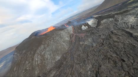 fpv drone perspective of fagradalsfjall volcano in iceland, while it dives over the lava crater