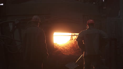 metal workers observing a furnace