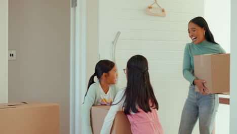 mother, kids and box at front door in new home