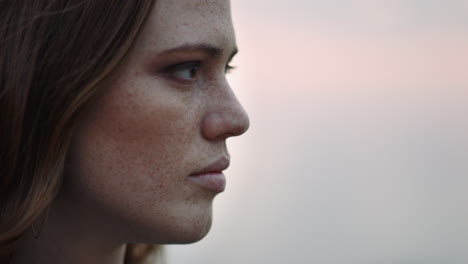 close up portrait of beautiful young woman looking up praying exploring spirituality contemplating future on cloudy seaside