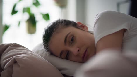 Close-up-video-of-depressed-woman-lying-in-bed