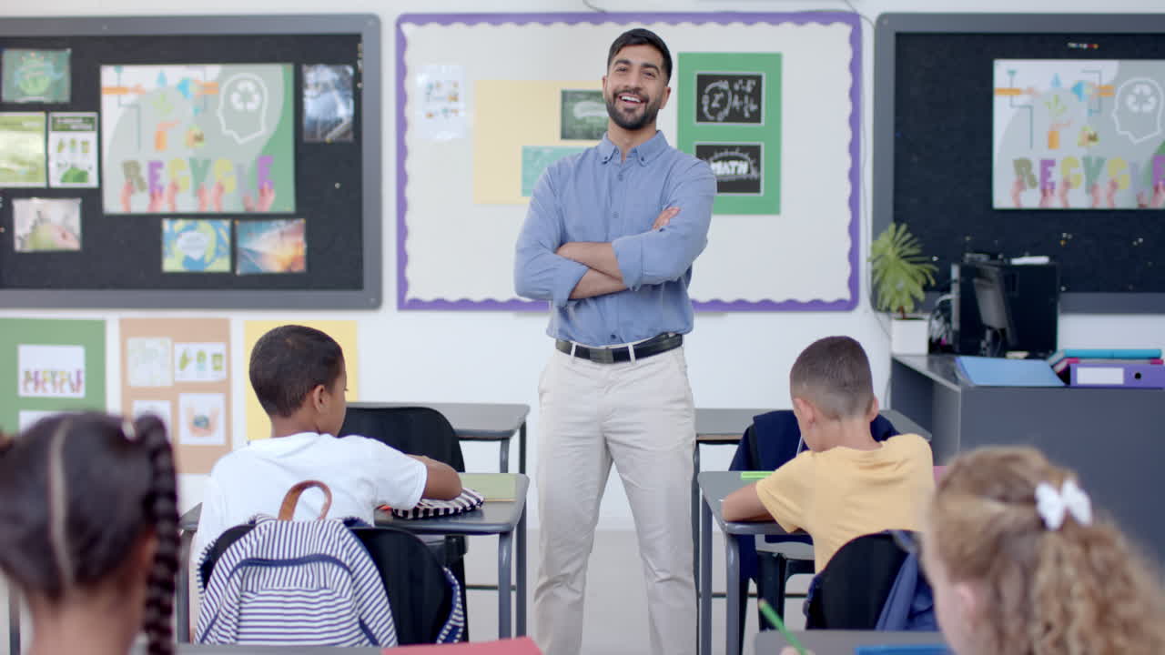 Confident teacher stands in a bright classroom at school