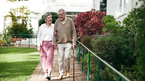 senior couple enjoying a walk in the garden