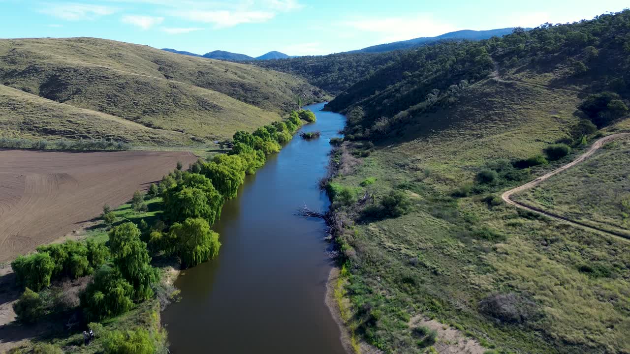 Drone aerial landscape of trees vegetation along riverbed creek water stream in bushland forest valley wilderness Murrumbidgee River Cooma Bredbo Australia nature outdoors rural town farmland
