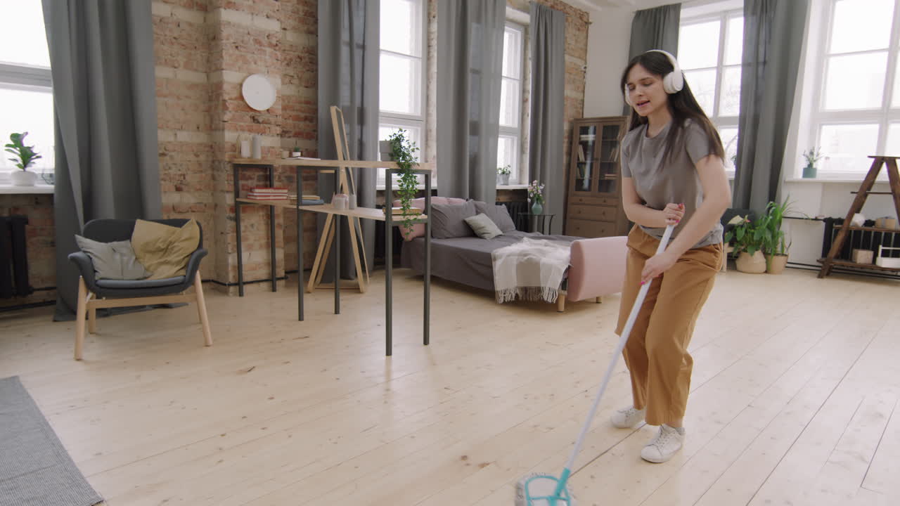 Slowmo of Woman Dancing and Mopping Floor
