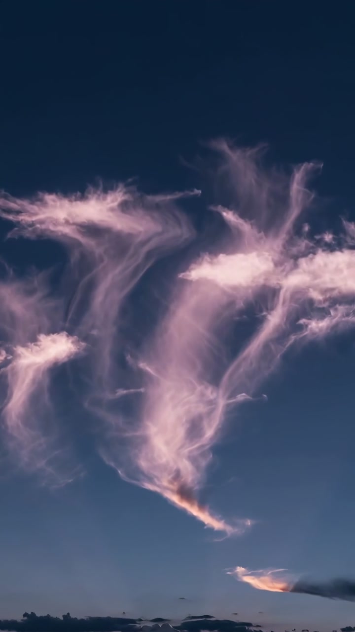 Sunlight striking three plumes at dusk, plumes stretching and trails fanning east aiding weather