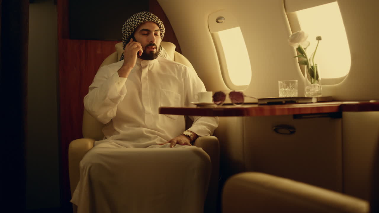 Professional speaking mobile phone in private jet. Businessman discussing work