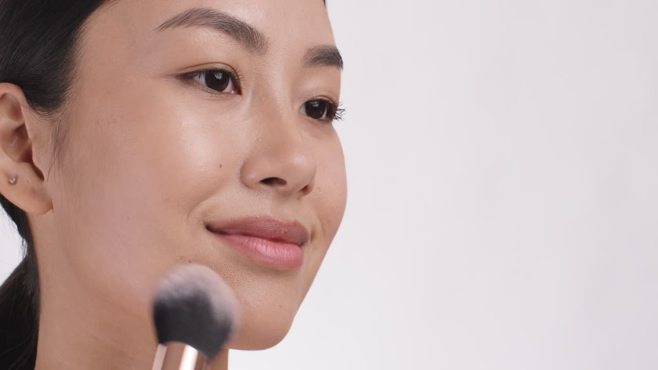 Woman applying makeup