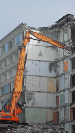 destroying old house with machine. demolition of the old industrial building
